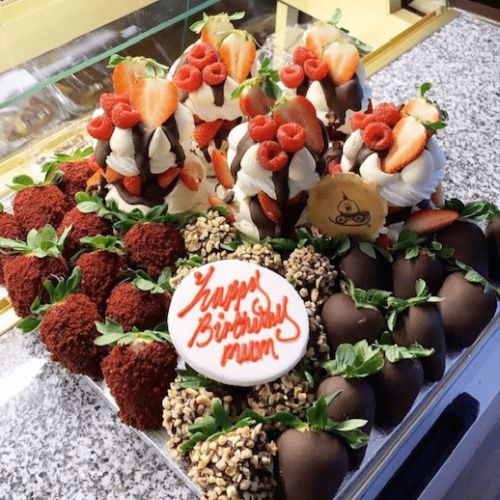 Pavlova and dipped strawberries platter